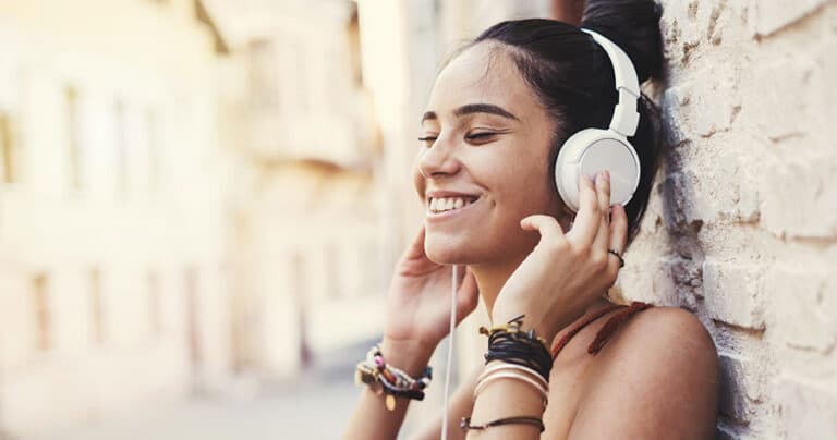 Beautiful young girl listening music